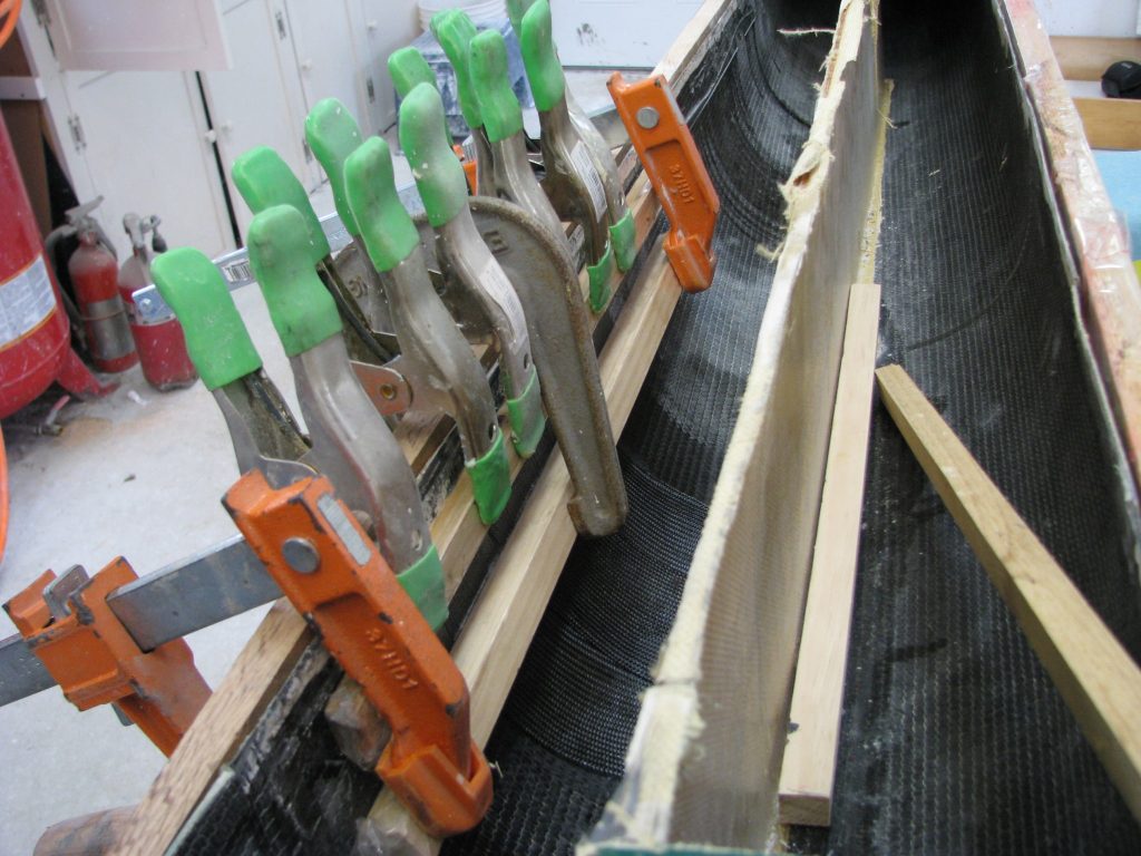Deck removal gave access to the fractured interior hull laminate and allowed us to reinforce it with temporary clamped stiffeners and lightweight carbon fiber and epoxy.