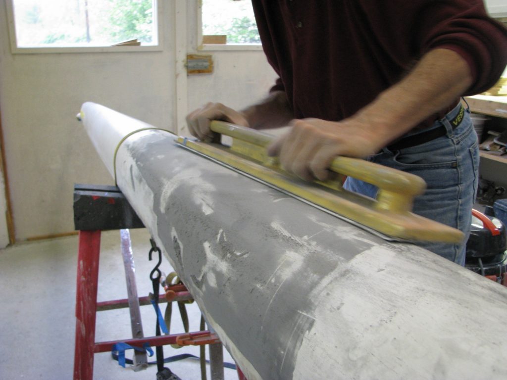 Shell Restoration: Longitudinal board sanding of fairing compound to perfect hull lines
